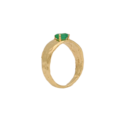 Organic gold ring with a green gemstone on a white background