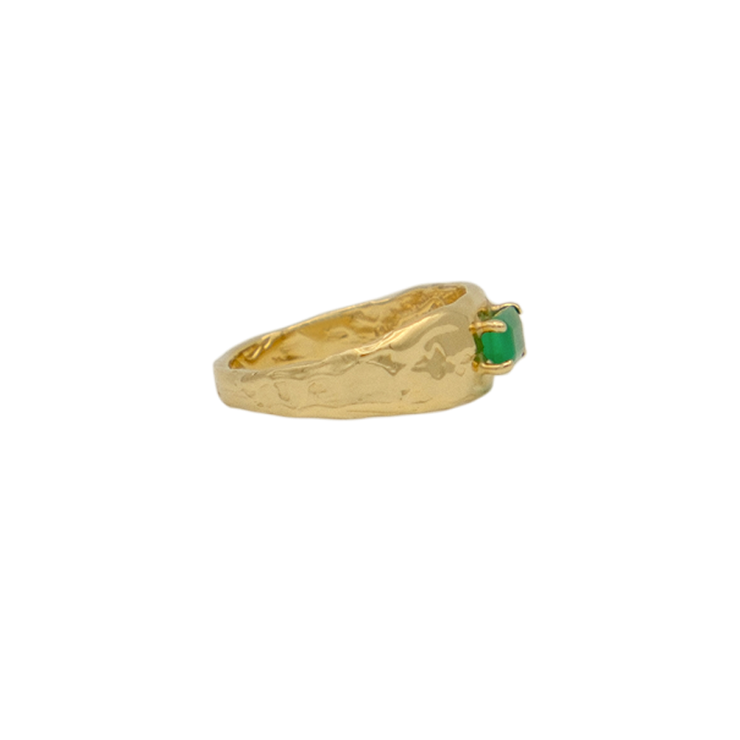 Organic gold ring with a green gemstone on a white background