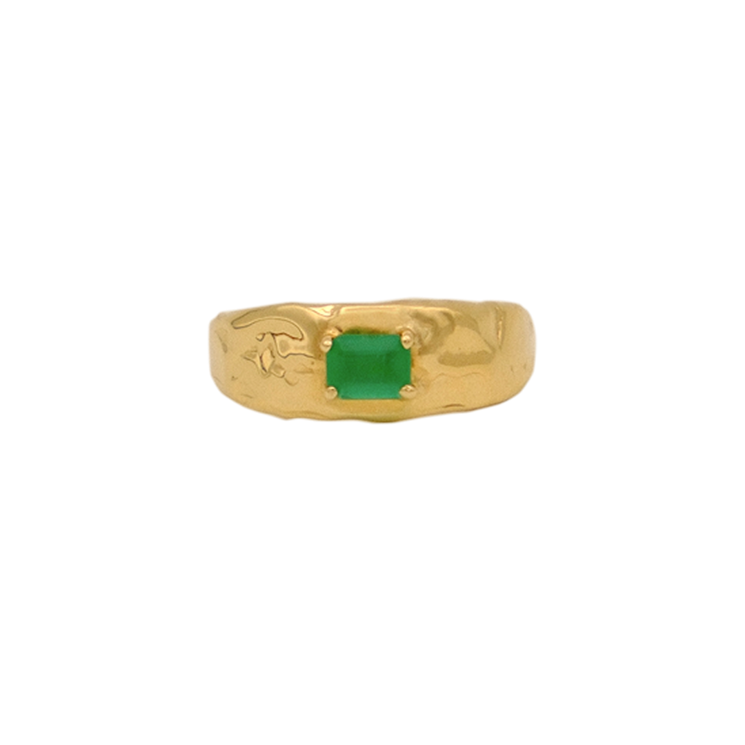 Organic gold ring with a green gemstone on a white background