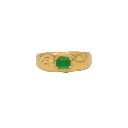 Organic gold ring with a green gemstone on a white background
