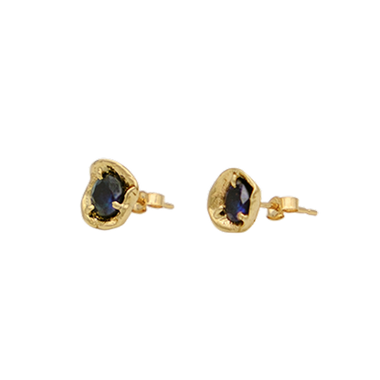 Gold earrings with blue gemstones on a white background