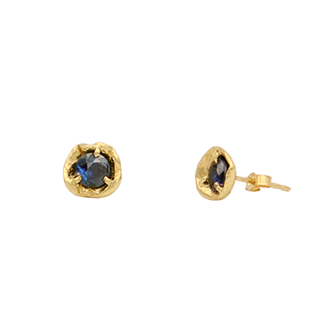 Gold earrings with blue gemstones on a white background