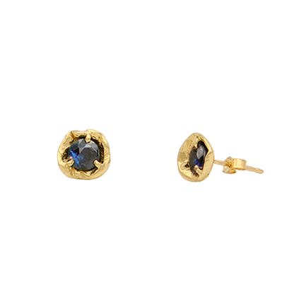Gold earrings with blue gemstones on a white background