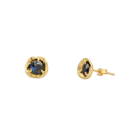 Gold earrings with blue gemstones on a white background