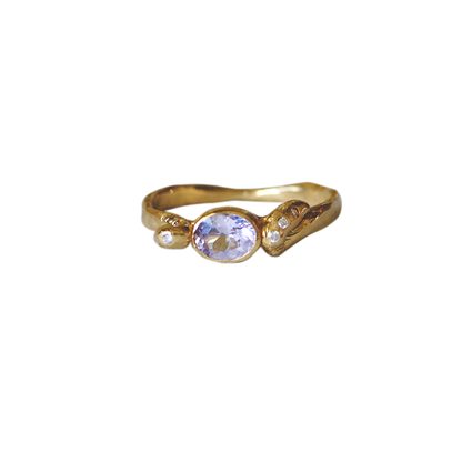 Gold ring with a lavender gemstone on a white background