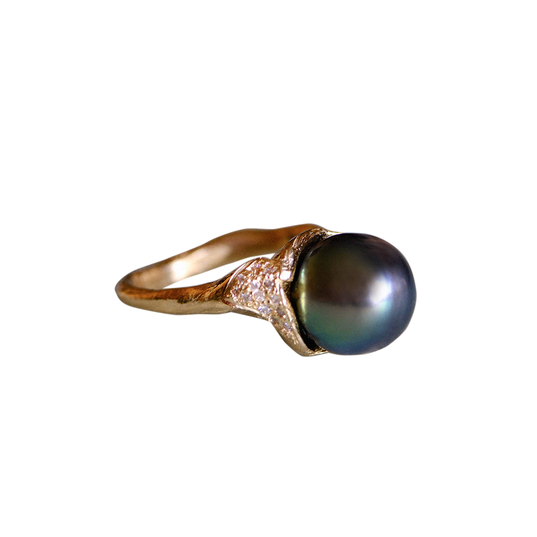 Organic gold ring with a large black pearl and small white diamonds on a white background