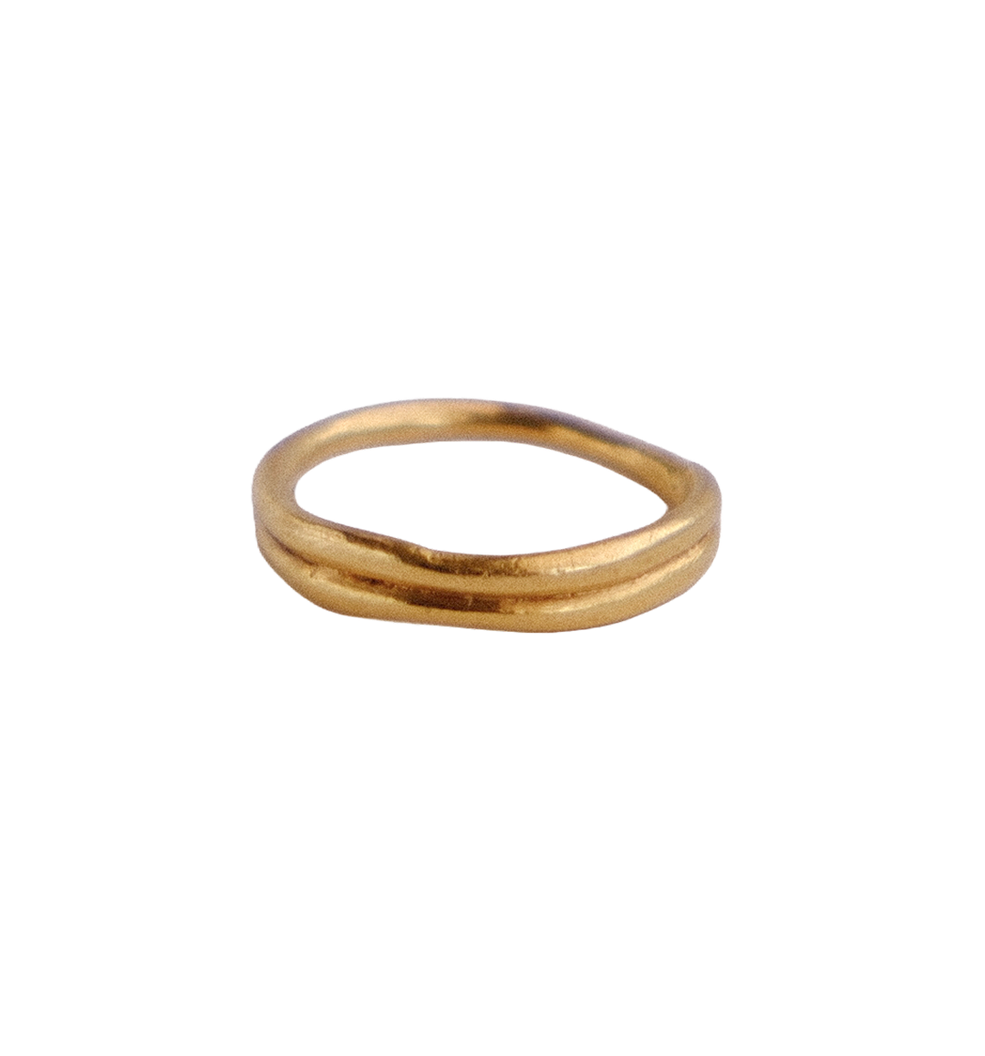 Organic double band gold ring against white background.