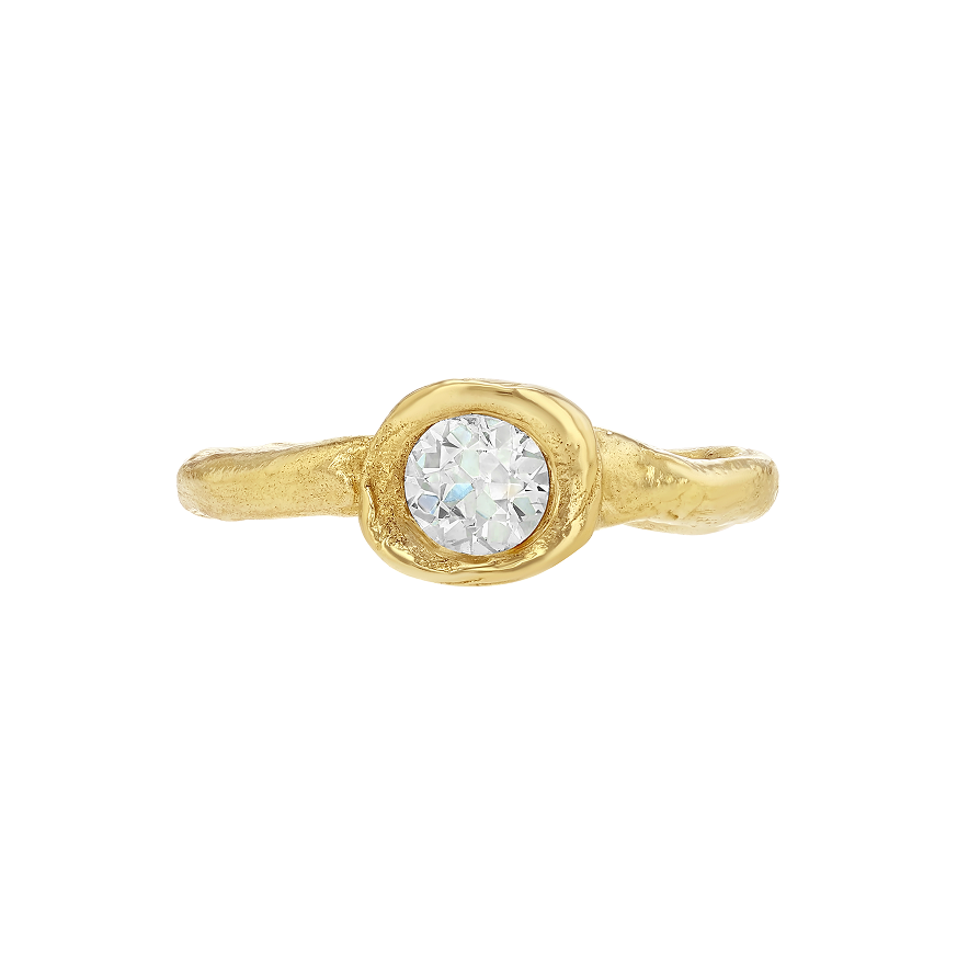 Organic gold ring with a round antique diamond on a white background