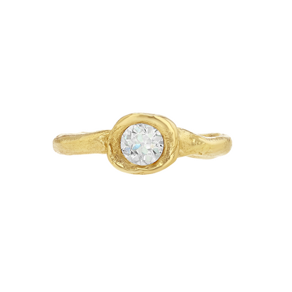 Organic gold ring with a round antique diamond on a white background