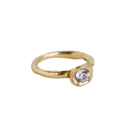 Organic gold ring with a round antique diamond on a white background